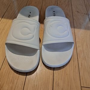 Cream COACH size 11 (women) slides with signs of wear